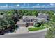 Aerial shot showcasing this home, mature trees, and a three car garage at 10142 Mountain Maple Dr, Highlands Ranch, CO 80129