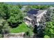 Home with solar panels, deck, green yard, and lush landscaping seen from above at 10142 Mountain Maple Dr, Highlands Ranch, CO 80129