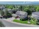 A picturesque aerial view of a two-story house in a neighborhood surrounded by lush greenery and trees at 10142 Mountain Maple Dr, Highlands Ranch, CO 80129