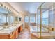 A Primary bathroom features dual sinks, a soaking tub and glass enclosed shower at 10142 Mountain Maple Dr, Highlands Ranch, CO 80129