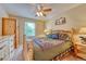 A rustic bedroom features wood furniture, a ceiling fan, and a window at 10142 Mountain Maple Dr, Highlands Ranch, CO 80129