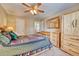 A rustic bedroom features wood furniture, a ceiling fan, and a window at 10142 Mountain Maple Dr, Highlands Ranch, CO 80129