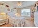 A bright bedroom with floral accents has a window letting in natural light at 10142 Mountain Maple Dr, Highlands Ranch, CO 80129