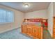 Comfortable bedroom with a wooden bed frame, built-in shelving, and a window at 10142 Mountain Maple Dr, Highlands Ranch, CO 80129