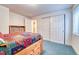 Cozy bedroom features a colorful quilt, wood trim, and closet for ample storage at 10142 Mountain Maple Dr, Highlands Ranch, CO 80129