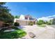 Beautiful two-story home with a three-car garage, manicured lawn, and mature trees at 10142 Mountain Maple Dr, Highlands Ranch, CO 80129