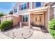 Charming front entrance with a brick exterior, double doors, and landscaped garden at 10142 Mountain Maple Dr, Highlands Ranch, CO 80129