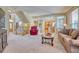 Bright living room featuring open floor plan, large windows, and seamless flow into the kitchen at 10142 Mountain Maple Dr, Highlands Ranch, CO 80129