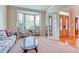 Comfortable living room with bay windows and view into the entry with a glass door at 10142 Mountain Maple Dr, Highlands Ranch, CO 80129