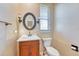 Stylish powder room with a decorative mirror, vanity, and toilet at 10142 Mountain Maple Dr, Highlands Ranch, CO 80129