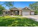 Inviting home with manicured lawn and front porch, featuring a three-car garage at 6297 E 167Th Ave, Brighton, CO 80602