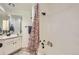 Clean bathroom featuring white tile, floral shower curtain, and modern fixtures at 14129 E Dickinson Dr # D, Aurora, CO 80014