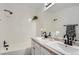 Well-lit bathroom featuring a tub and shower, a double sink, and a full mirror at 14129 E Dickinson Dr # D, Aurora, CO 80014