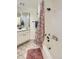 This bathroom has a shower and tub combination with floral curtain at 14129 E Dickinson Dr # D, Aurora, CO 80014