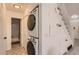 Convenient laundry area near staircase with stacked washer and dryer and updated flooring at 14129 E Dickinson Dr # D, Aurora, CO 80014