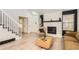 Comfortable living room showing a staircase, decor, wood flooring, and a fireplace at 14129 E Dickinson Dr # D, Aurora, CO 80014