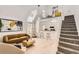 Airy living room featuring a lofted ceiling, modern decor, and seamless flow to the kitchen at 14129 E Dickinson Dr # D, Aurora, CO 80014