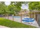 Community pool is surrounded by black fencing and lush trees and foliage at 14129 E Dickinson Dr # D, Aurora, CO 80014