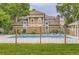 Community pool is surrounded by black fencing and lush trees and foliage at 14129 E Dickinson Dr # D, Aurora, CO 80014