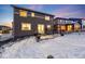 Two-story home with backyard patio, snow covered yard, and a partially visible grilling area at 2633 Garganey Dr, Castle Rock, CO 80104