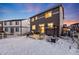 Two-story home with backyard patio, snow covered yard, and a partially visible grilling area at 2633 Garganey Dr, Castle Rock, CO 80104