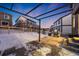 Covered patio area with a grill and snowy yard at 2633 Garganey Dr, Castle Rock, CO 80104