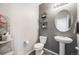 Modern bathroom with pedestal sink, toilet and gray walls at 2633 Garganey Dr, Castle Rock, CO 80104