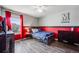 Bright bedroom with red and gray decor at 2633 Garganey Dr, Castle Rock, CO 80104