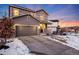 Two-story house with gray siding, attached garage, and front porch, dusk at 2633 Garganey Dr, Castle Rock, CO 80104