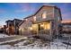 Two-story house with gray siding, attached garage, and front porch, dusk at 2633 Garganey Dr, Castle Rock, CO 80104