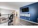 Home office with a view of the hallway, dark hardwood floors and a large TV at 2633 Garganey Dr, Castle Rock, CO 80104