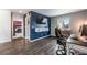 Home office with a view into a bedroom, dark hardwood floors and a large TV at 2633 Garganey Dr, Castle Rock, CO 80104