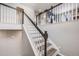 Elegant staircase with dark wood railings and light gray walls at 2633 Garganey Dr, Castle Rock, CO 80104