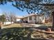 Charming backyard with a lawn, patio, garden bed and mature trees at 5175 Quari St, Denver, CO 80239