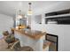 Finished basement featuring a granite-topped bar, seating, built-in shelving, and a beverage fridge at 5175 Quari St, Denver, CO 80239