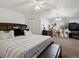 Bright bedroom with ceiling fan, featuring neutral walls, carpet and contemporary furnishings and decor at 5175 Quari St, Denver, CO 80239