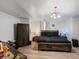 Modern bedroom featuring neutral walls, wood-look flooring and contemporary furnishings and dark wood furniture at 5175 Quari St, Denver, CO 80239