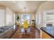 Cozy dining area features wood floors, a modern chandelier, and multiple windows for plenty of natural light at 5175 Quari St, Denver, CO 80239