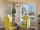 Bright dining area includes a large window and comfortable seating under modern chandelier at 5175 Quari St, Denver, CO 80239