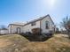 Exterior of home showcasing architecture and large yard with access to covered patio at 5175 Quari St, Denver, CO 80239