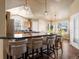 Open-concept kitchen featuring a large island with seating, pendant lighting, and stainless steel appliances at 5175 Quari St, Denver, CO 80239