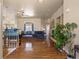 Spacious living room with hardwood floors, stone fireplace, and large windows for natural light at 5175 Quari St, Denver, CO 80239