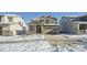 Two-story house with gray siding, stone accents, and a two-car garage at 238 Kino Court, Brighton, CO 80601