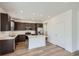 Modern kitchen with island and stainless steel appliances at 238 Kino Court, Brighton, CO 80601