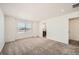 Main bedroom with carpet, large window and ensuite bathroom at 238 Kino Court, Brighton, CO 80601