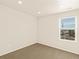 Well-lit bedroom featuring a large window and carpet flooring at 22290 E 8Th Pl, Aurora, CO 80018