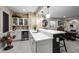Stylish basement bar with stone accents, pendant lights, and ample counter space at 5707 Cadara Way, Parker, CO 80134