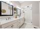 Elegant bathroom with double vanities and an expansive walk-in shower with tiled walls and showerhead at 5707 Cadara Way, Parker, CO 80134