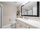 Well-lit bathroom with a white vanity, a black-framed mirror, and a separate shower enclosure at 5707 Cadara Way, Parker, CO 80134
