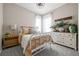 Cozy bedroom with neutral walls, plush carpeting, and ample natural light from the large windows at 5707 Cadara Way, Parker, CO 80134